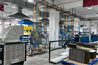 Assembly area with coil and cabinet workstations under an overhead gantry